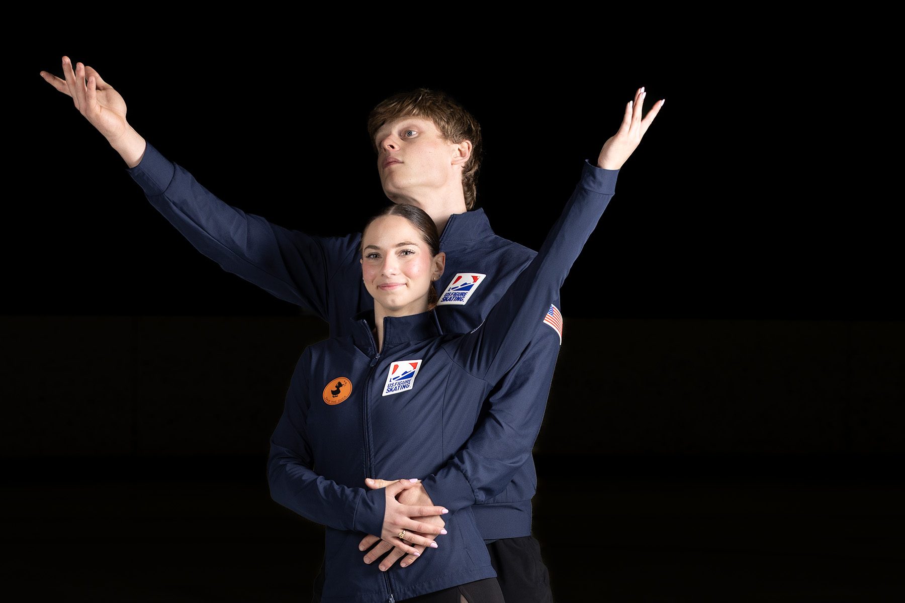 Figure skating pair in an elegant embrace pose on the ice — A2 Portraits, Ann Arbor athlete portraits