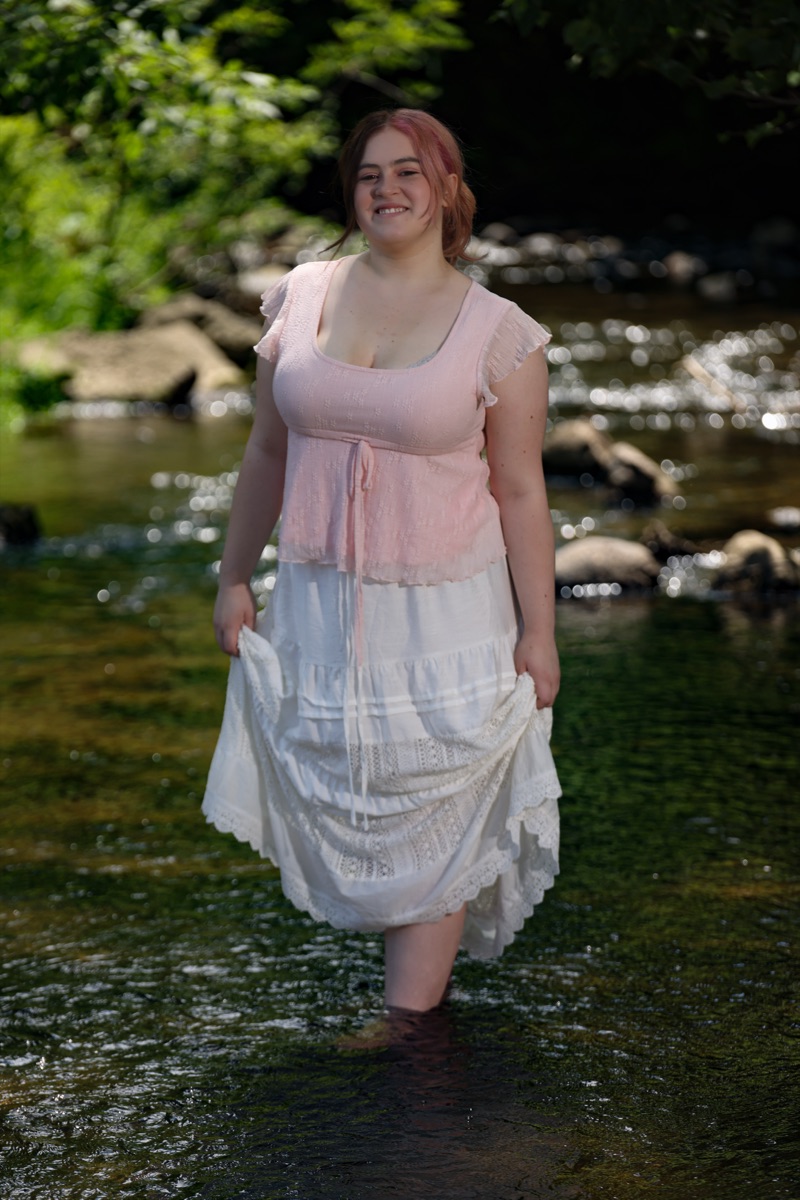Senior portrait of Peyton in a pink top standing in a creek — Ann Arbor fine art portraiture